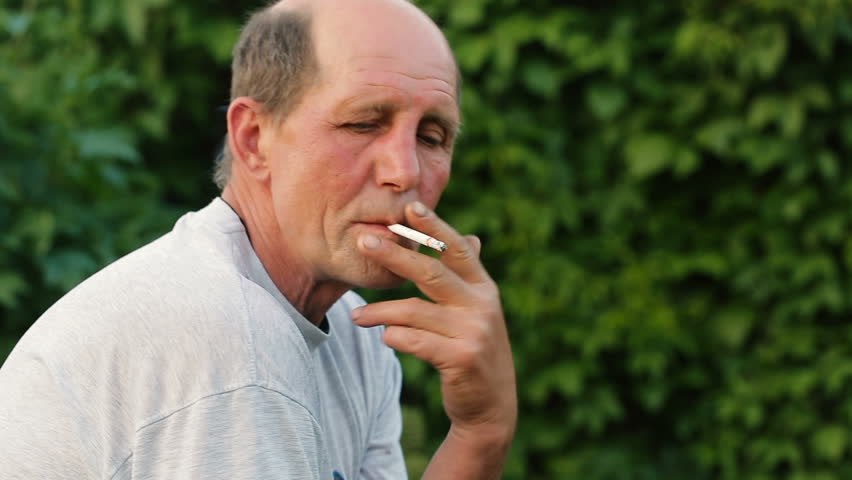 Man Smoking Cigarette In A Park - Stock Video