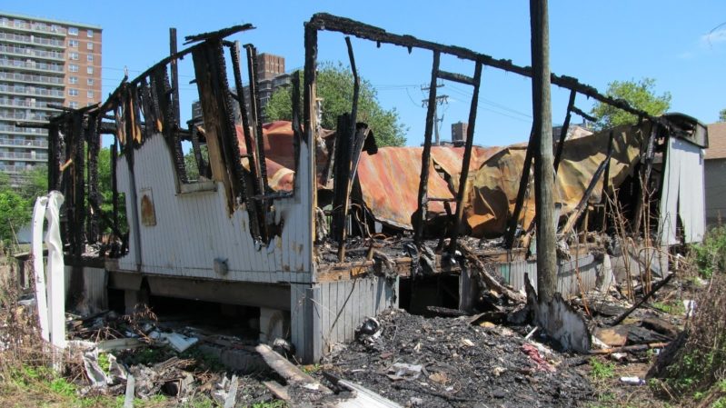 Burned down ruins of house, frame still up and debris everywhere.