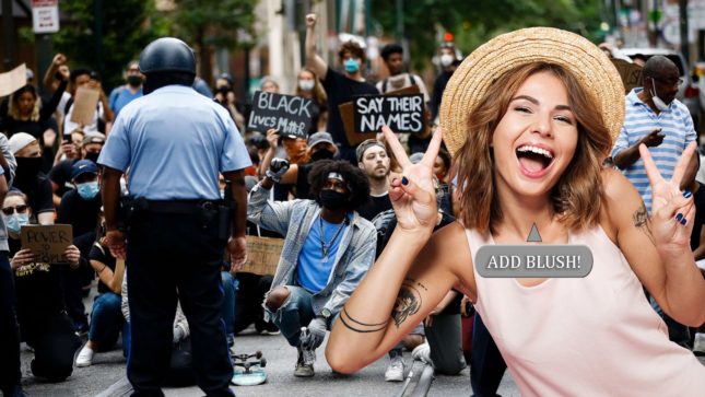 Woman with an open mouth, light brown hair flashing two peace signs in front of a Black Lives Matter rally, wearing a pink shirt and a large hat, and with a button that says "ADD BLUSH" on it indicating that it is a photo editing portion of the app.