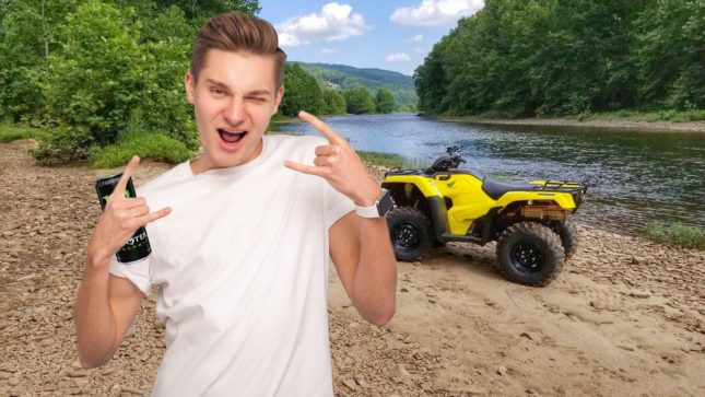 20-something-year-old guy with dark blonde hair and brown eyes wearing a white shirt with both of his hands in a "rock n' roll" position. He is standing on dirt with an ATV, a lake, and a tree in the background.