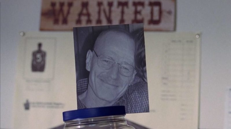 Walter White donation jar under a "WANTED" sign on the board.