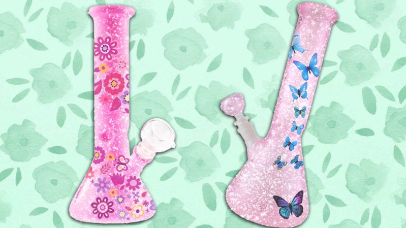 2 pink bongs with hot pink flowers and blue butterflies on them. There is a soft green background with slightly darker green flowers on it.